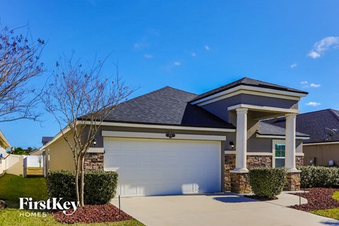 a house with a garage door in front of it