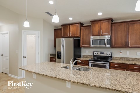 a kitchen with a granite counter top and a sink