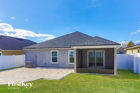 a small house with a backyard and a blue sky