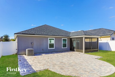 a backyard with a patio and a house