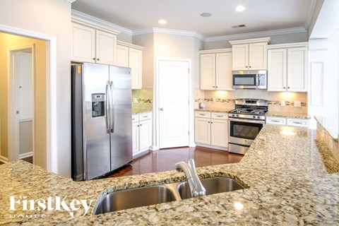A kitchen with granite countertops and stainless steel appliances.