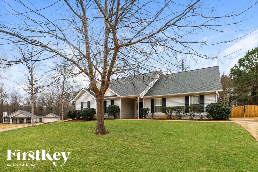 A house with a tree in front of it and the words "FirstKey Homes" on the bottom left.