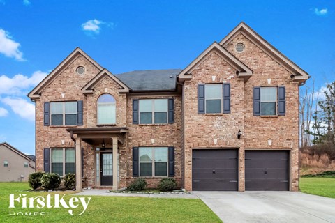 a large brick house with two garage doors
