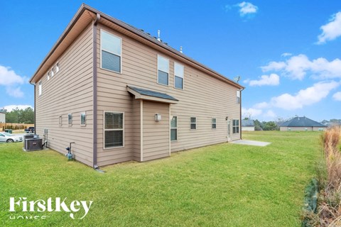 a home with a brown and and a grass field