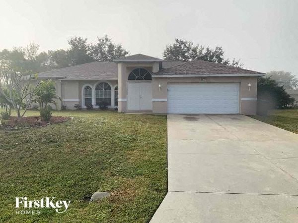 A house with a driveway in front of it.