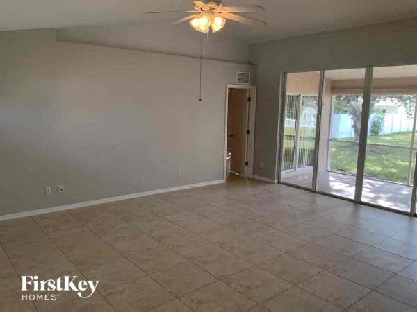 A room with a tile floor and a ceiling fan.