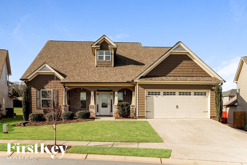 A house with a brown roof and a garage door.