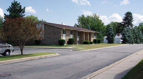 a house with a car parked in front of it on a street