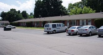 a parking lot with cars in front of a building