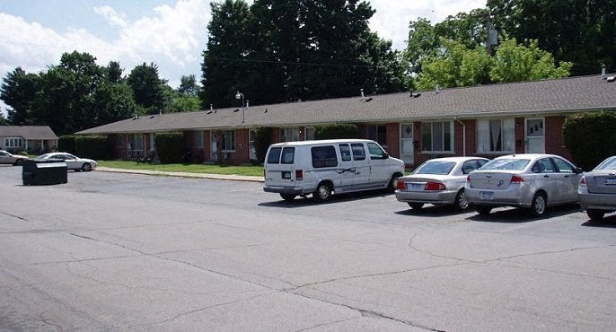 a parking lot with cars in front of a building