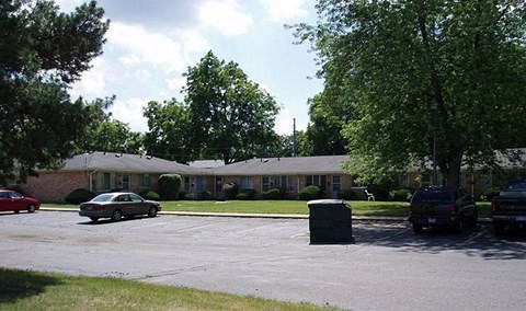 a house with cars parked in a parking lot