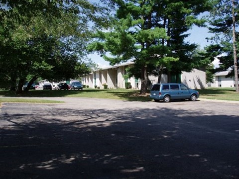 a blue car parked in front of a house