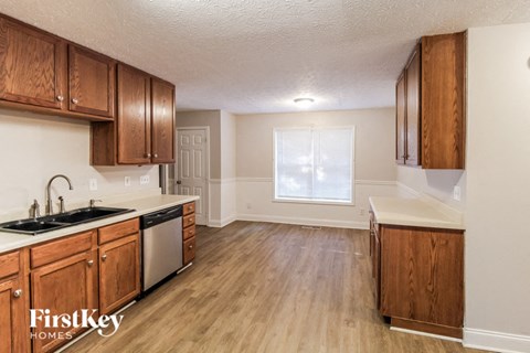 a kitchen with wooden cabinets and a sink and a window
