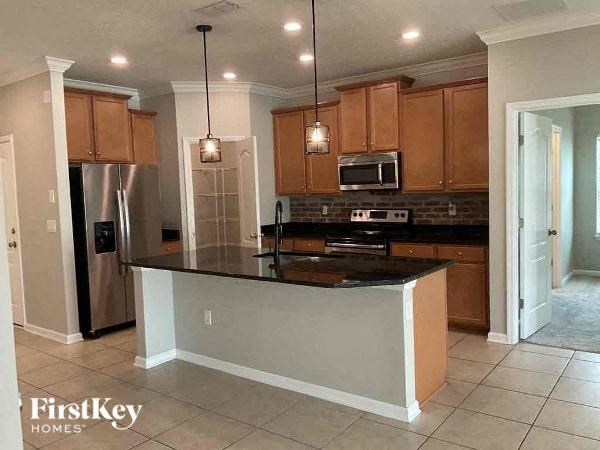 a kitchen with a counter top and a refrigerator