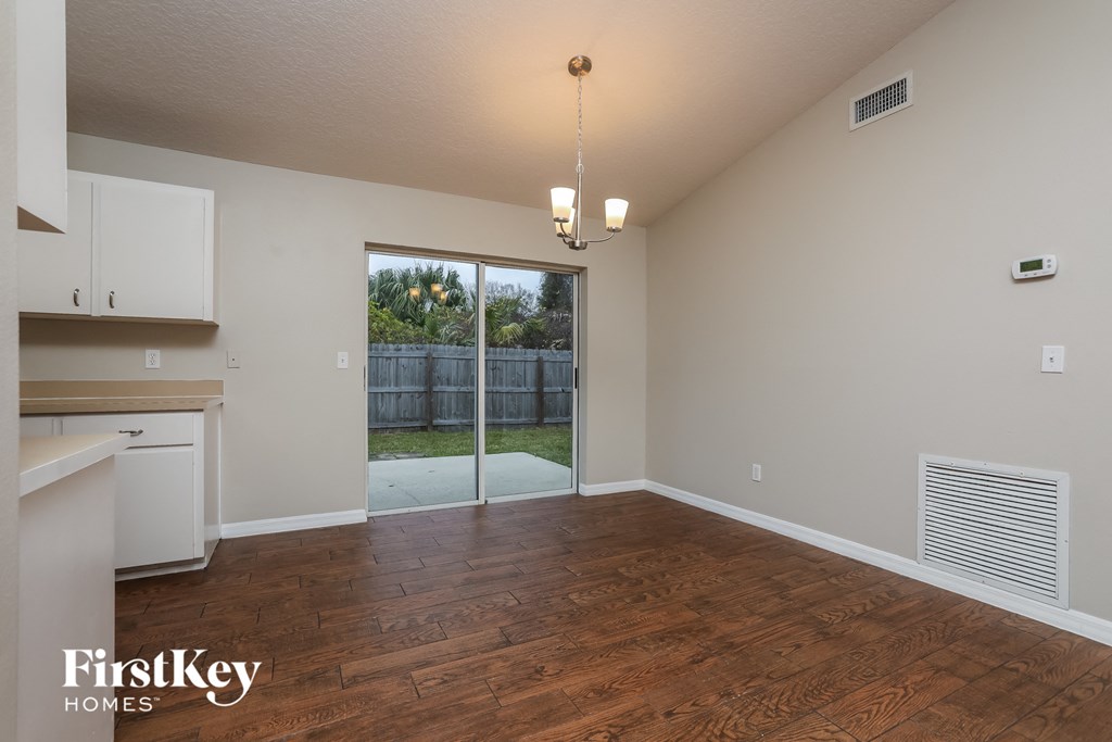 a kitchen and living room with wood flooring and a sliding glass door