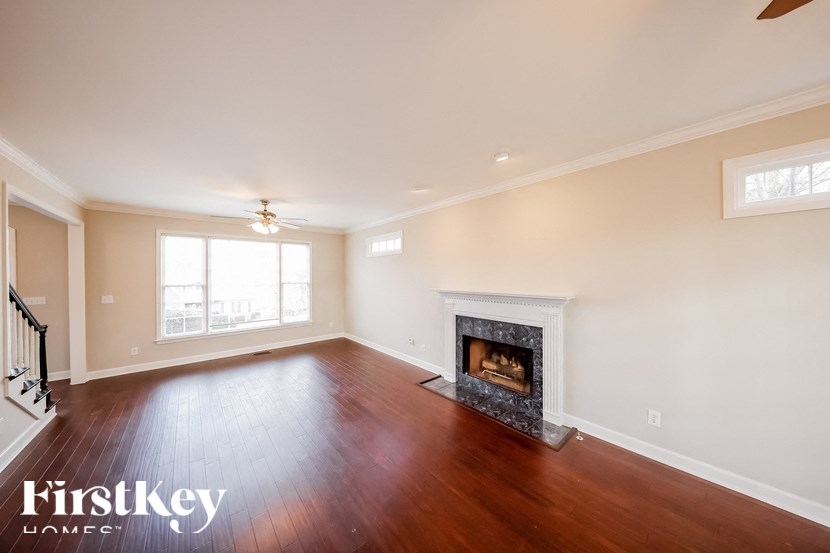 a living room with a fireplace and wooden floors
