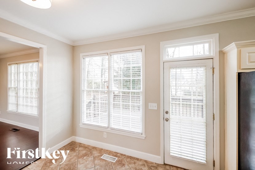 a living room with two windows and a door