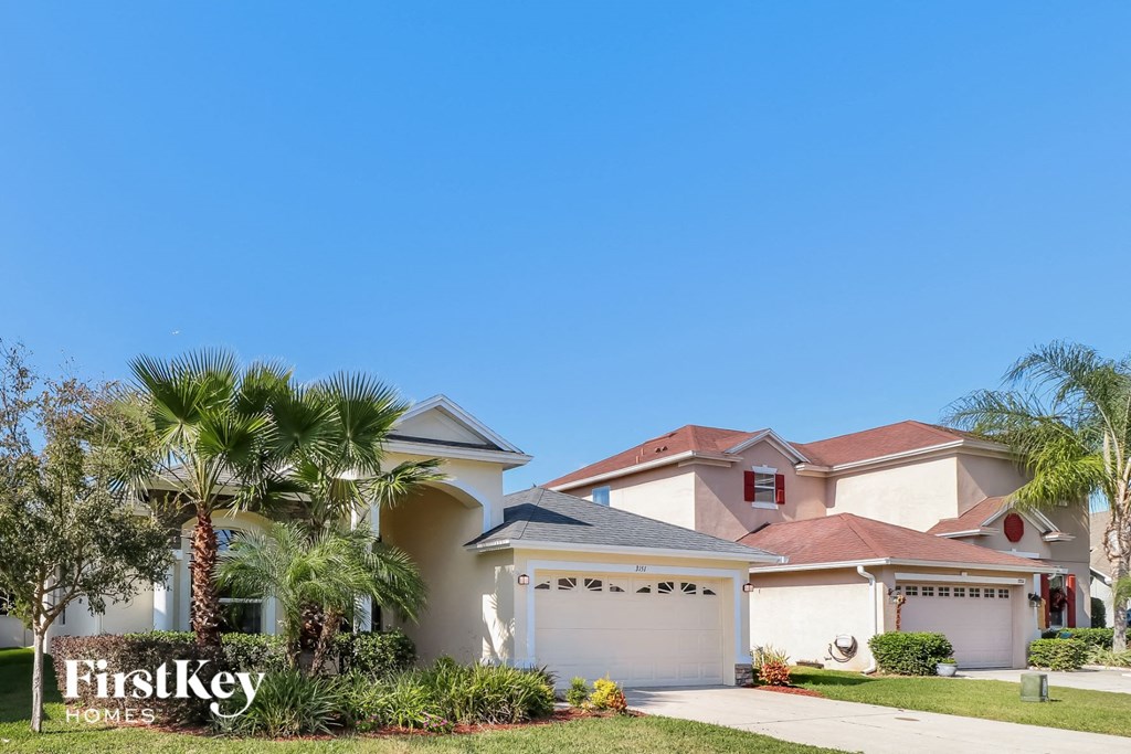 a house with palm trees in front of it