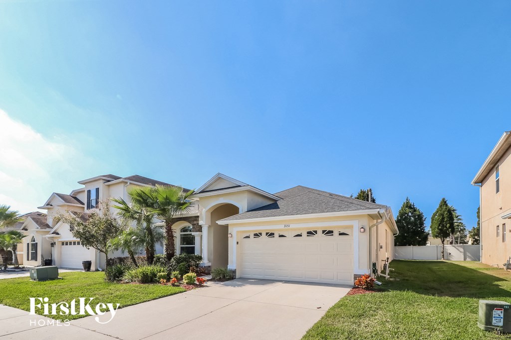 a house with a garage door and a lawn