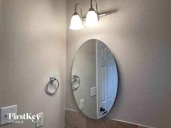 a bathroom with a large mirror and two lights