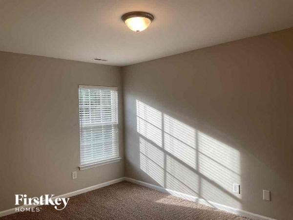 a bedroom with a large window and a light on the ceiling