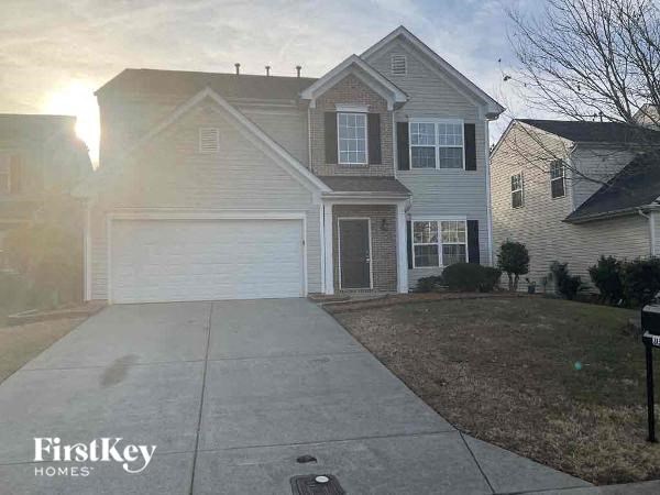 a white house with a sidewalk in front of it