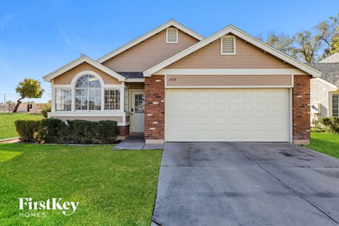 a home with a white garage door and a driveway