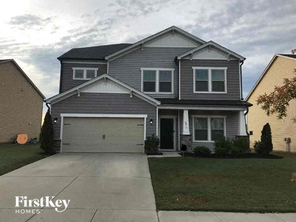 a suburban house with a driveway and a garage door