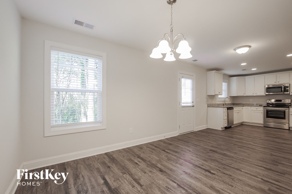 the kitchen and living room of a new home