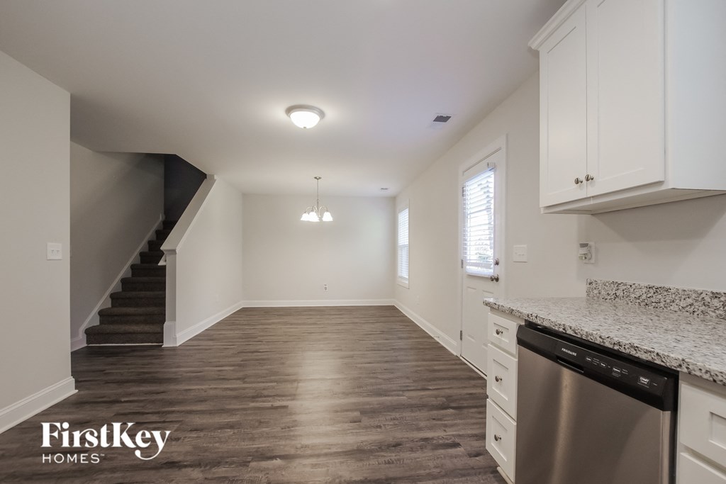 a renovated kitchen with white cabinets and a stainless steel dishwasher