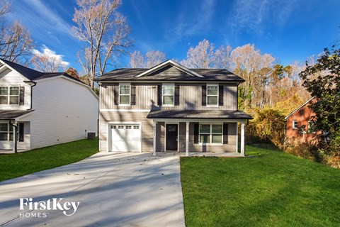 a suburban house with a driveway and a garage door