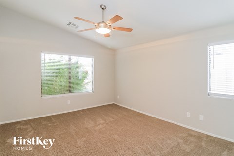 a bedroom with a ceiling fan and a window