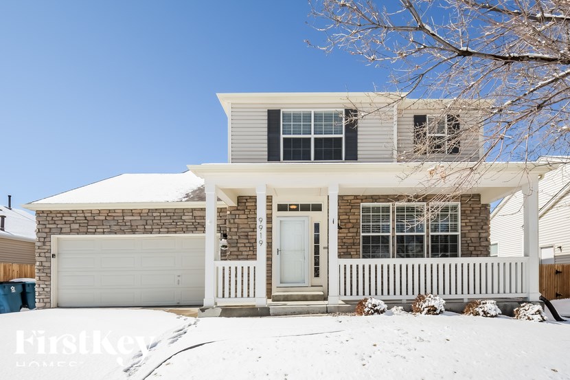 A house with a snow-covered front yard.