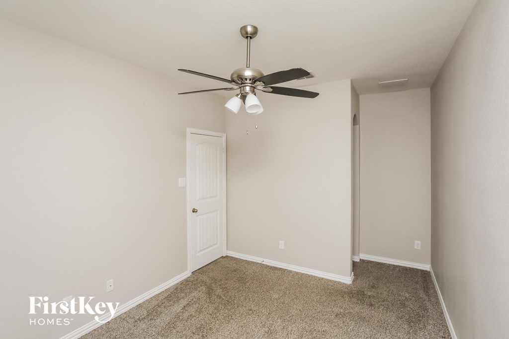 a bedroom with a ceiling fan and a closet