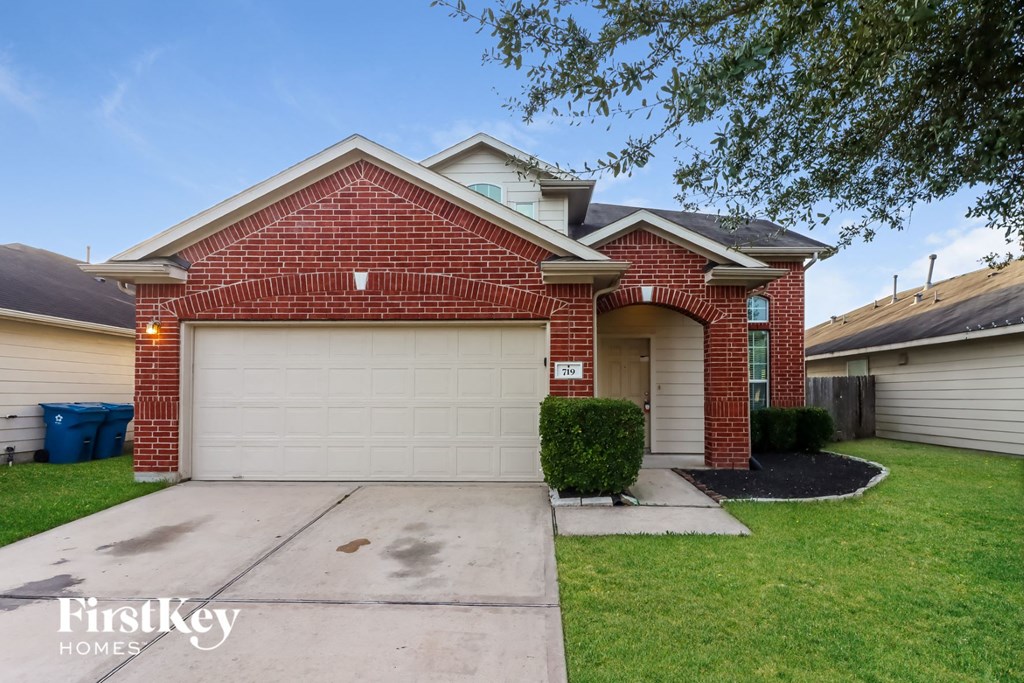 a brick home with a white garage door