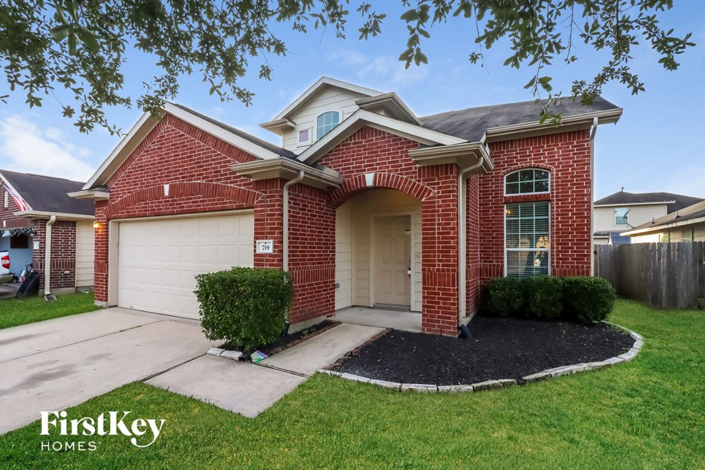 a red brick home with a white garage door