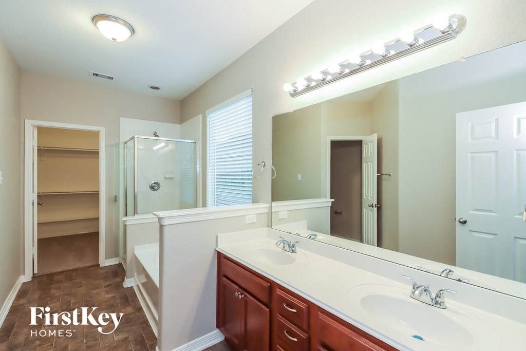 a bathroom with two sinks and a large mirror