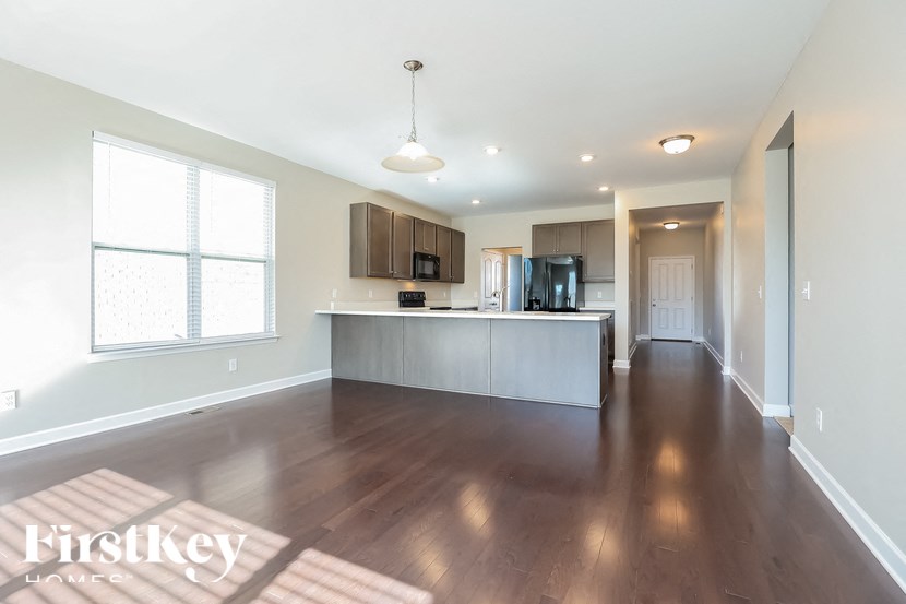 A spacious kitchen with wooden floors and a central island.