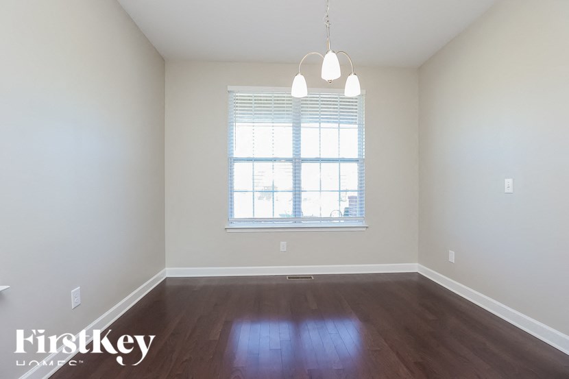 A room with a window and wooden floors.