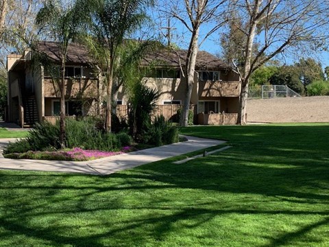 A building with a green lawn in front of it.