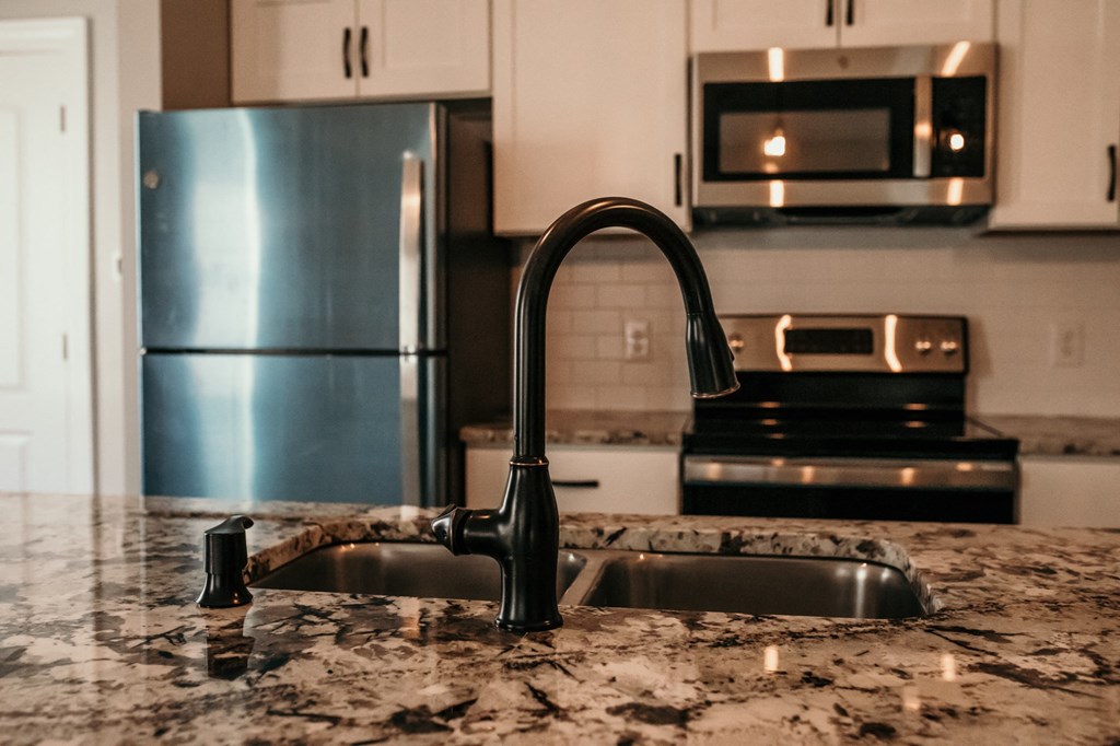 a kitchen with granite counter tops and a sink