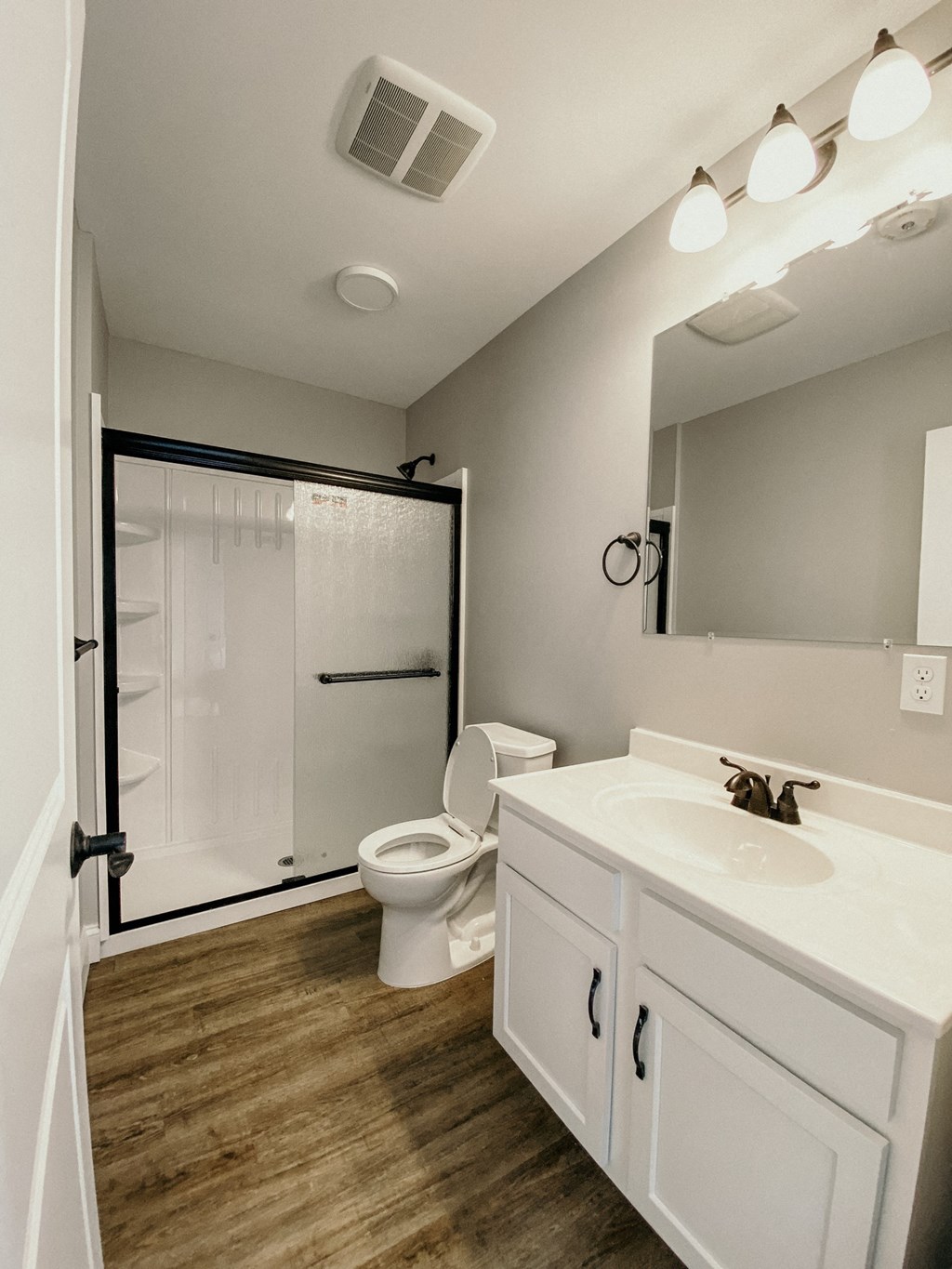 a bathroom with a toilet and a sink and a shower