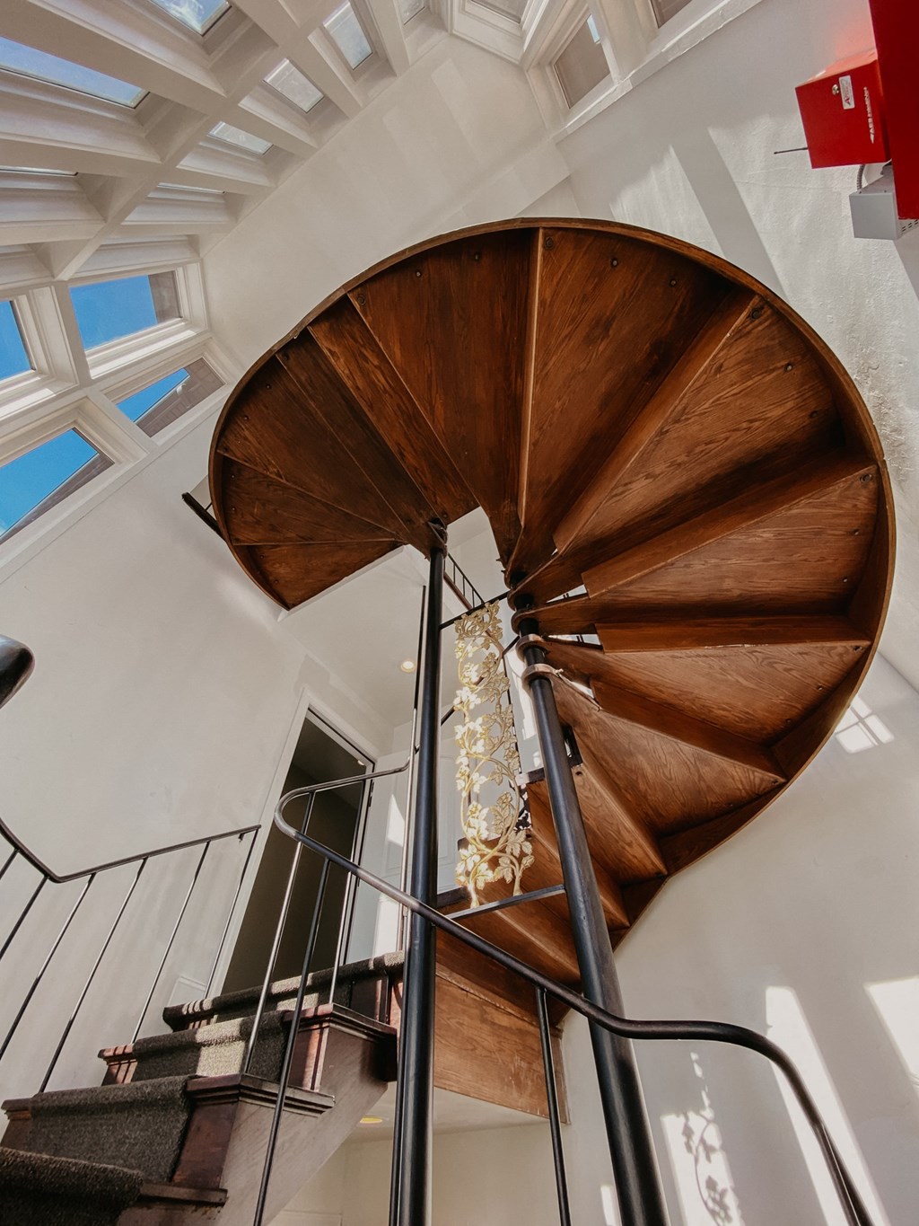 a spiral staircase with a wooden propeller on the side of it