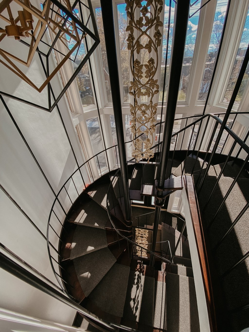 a spiral staircase with a view of a window in a building