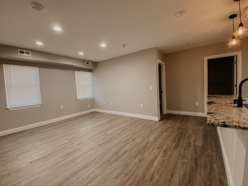 the living room and dining room of a new home with wood flooring