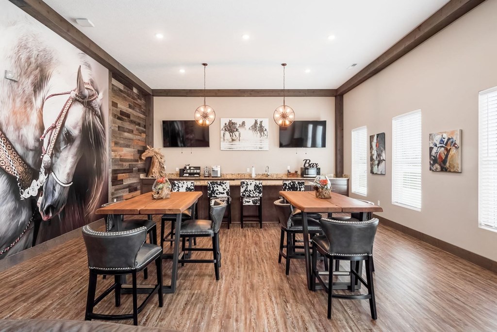 a dining room with tables and chairs and a bar