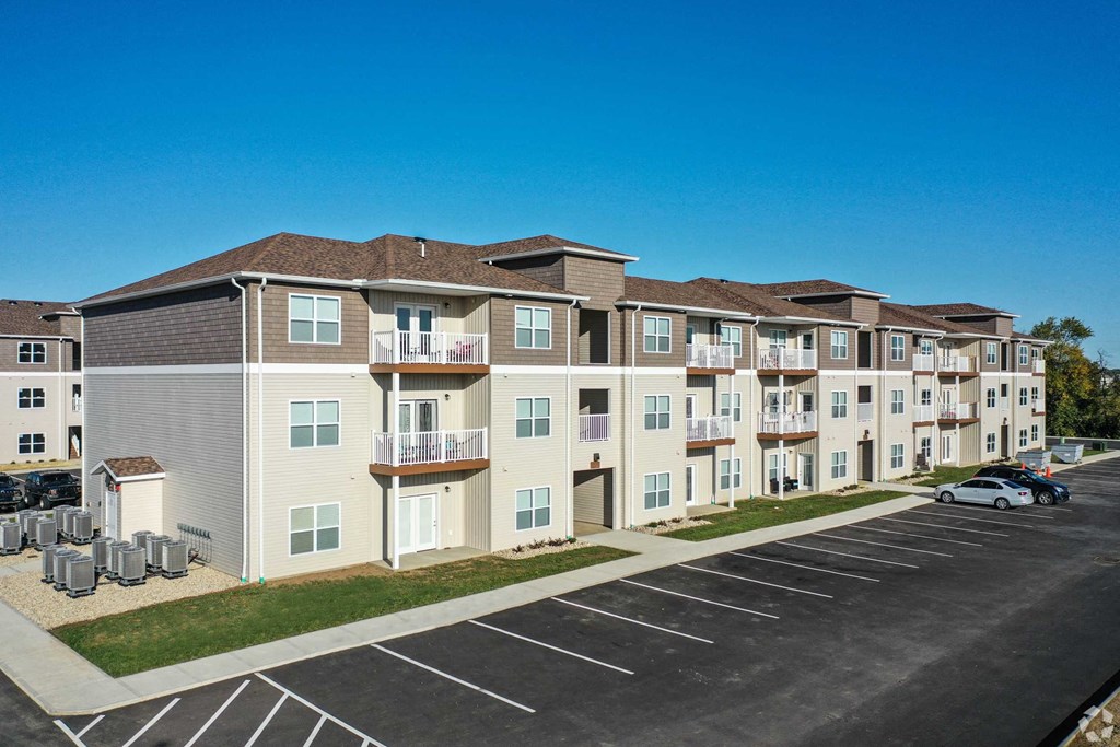 an image of an apartment building in a parking lot