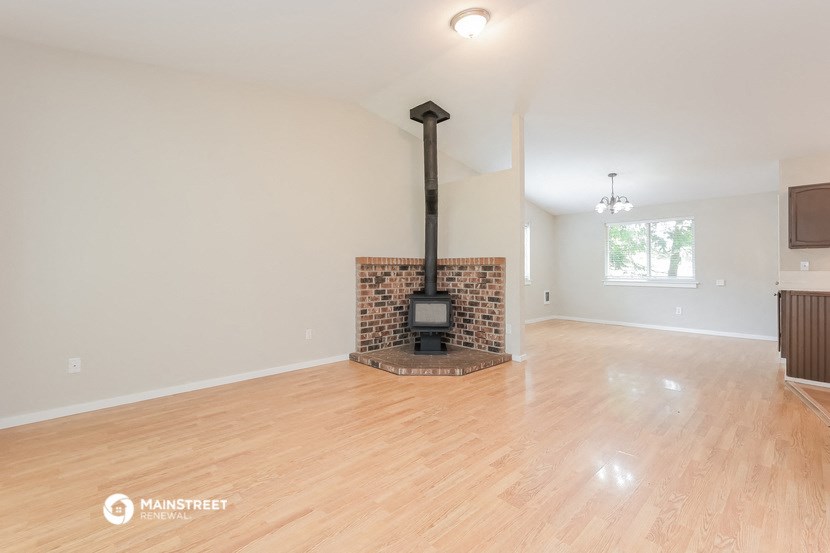 a living room with a fireplace and a wooden floor
