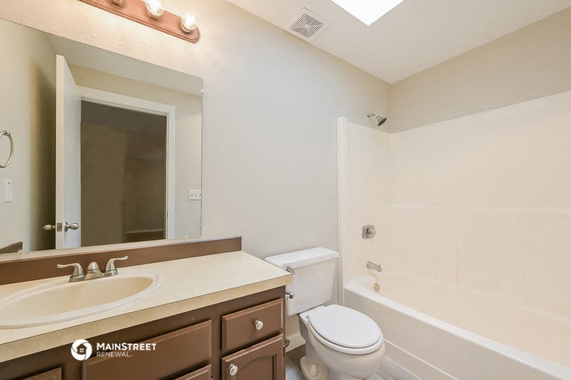 a bathroom with a sink and a toilet and a shower