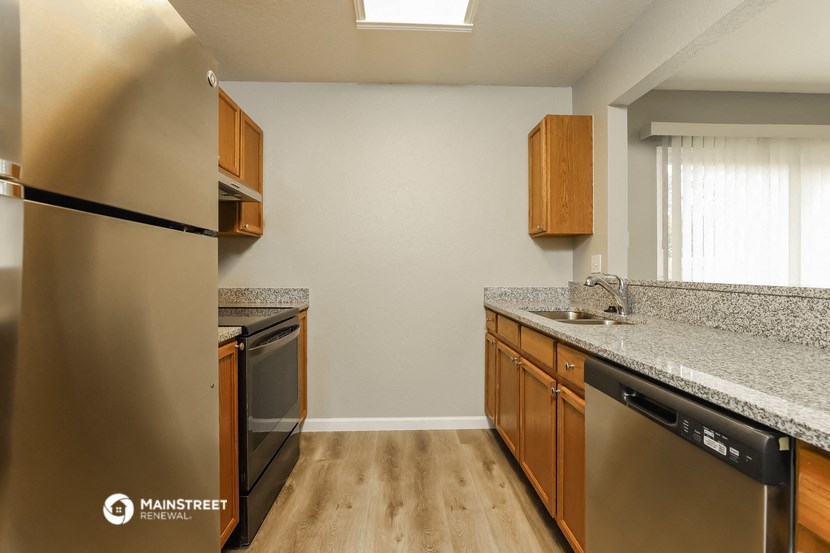 a kitchen with granite counter tops and stainless steel appliances